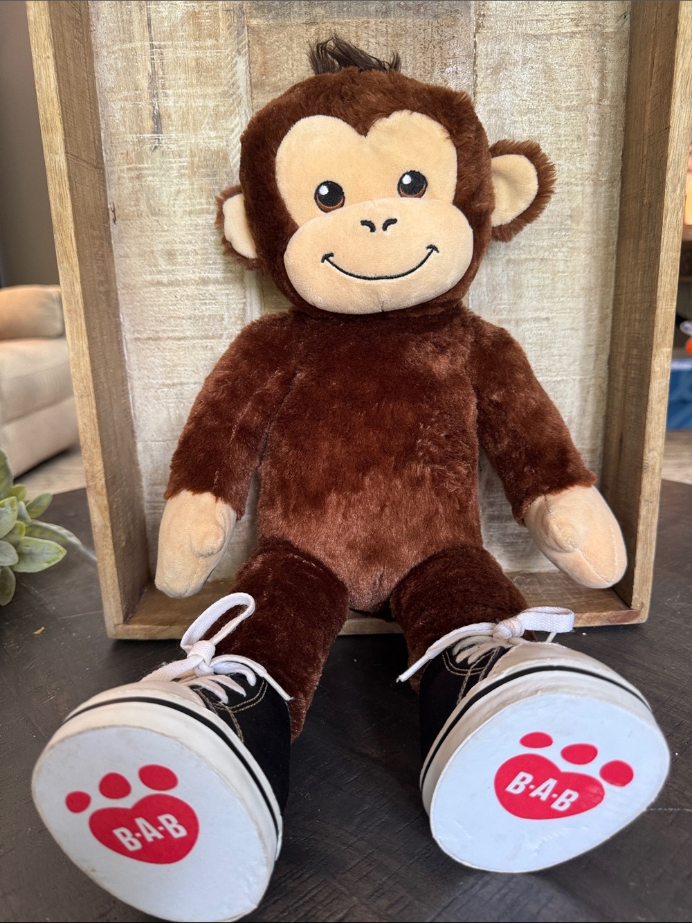 Build-A-Bear Workshop Smiley Monkey features a signature paw print logo